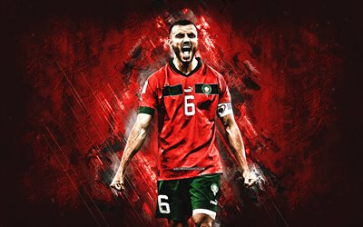 romain saiss, marokon jalkapallomaajoukkue, qatar 2022, marokon jalkapalloilija, puolustaja, punainen kivi tausta, marokko, jalkapallo