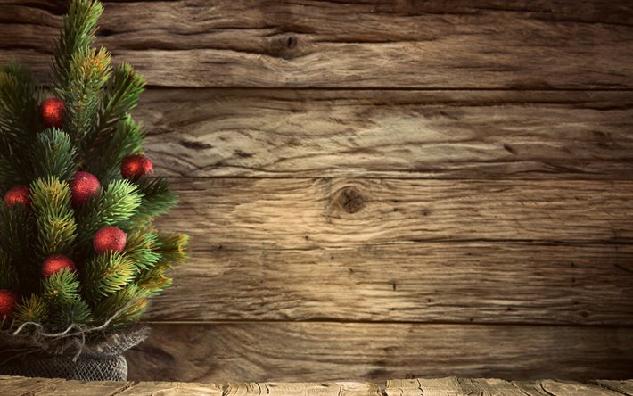 julgran, röda julkulor, brun träbakgrund, nyår, dekoration