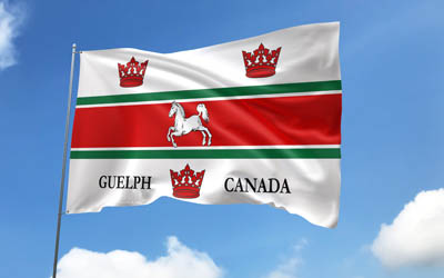 guelph  flagga på flaggstång, 4k, kanadensiska städer, blå himmel, guelphs flagg, wavy satinflaggor, guelph flagga, städer i kanada, flaggstång med flaggor, guelph day, canada, guelph