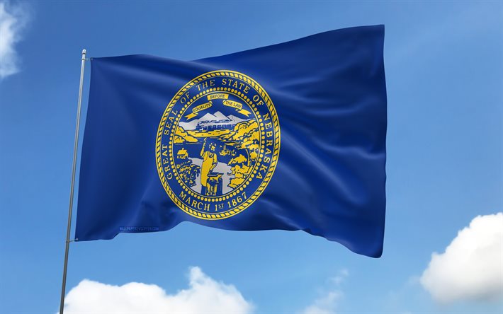 Nebraska flag on flagpole, 4K, american states, blue sky, flag of Nebraska, wavy satin flags, Nebraska flag, US States, flagpole with flags, United States, Day of Nebraska, USA, Nebraska