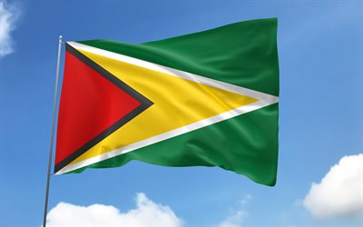 guyana flagga på flaggstången, 4k, sydamerikanska länder, blå himmel, guyanas flagga, vågiga satinflaggor, guyans flagga, guyanesiska nationella symboler, flaggstång med flaggor, guyanas dag, sydamerika, guyana flagga, guyana