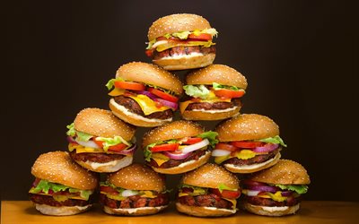 a mountain of burgers, cheeseburgers, junk food